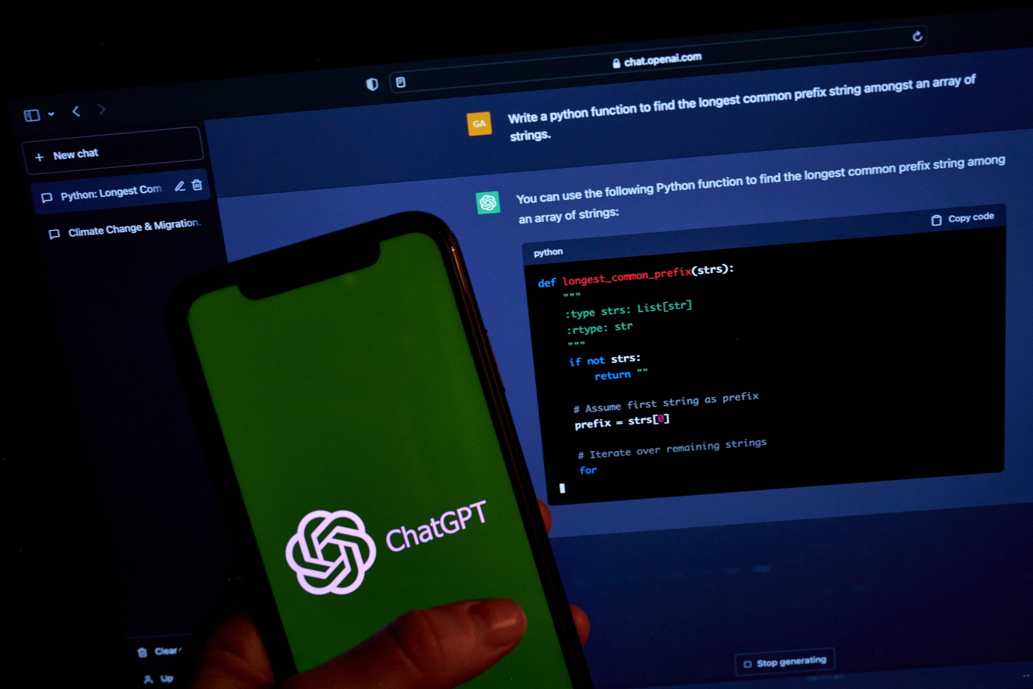 ChatGPT logo on phone with laptop